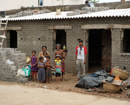 The Patra family before the shell of their new house